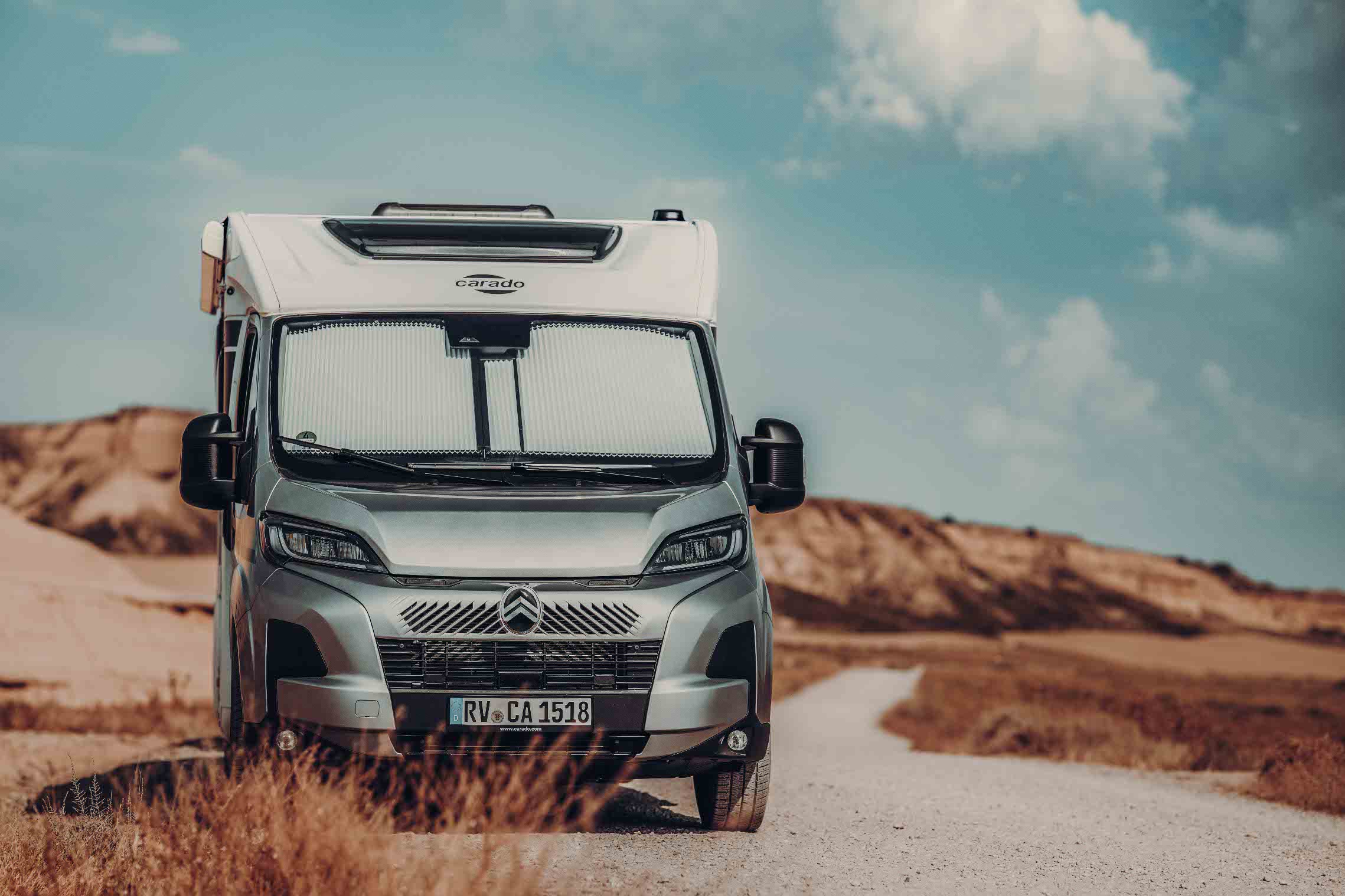 A Carado motorhome on the road in summer in sweltering heat